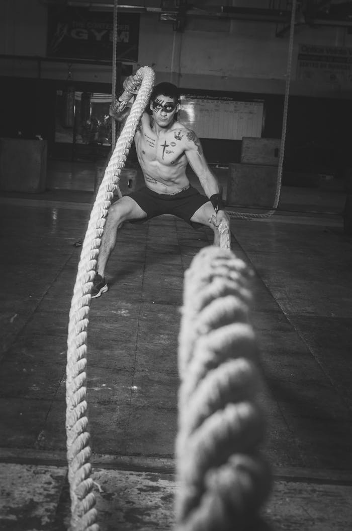 Young athlete performing battle rope exercise in Ciudad Juárez gym, Mexico.